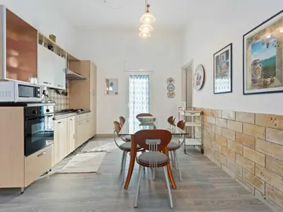 a kitchen with a table and chairs in it at Apartment in Alcamo near the Beach in Alcamo Marina