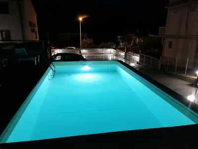 a swimming pool with blue lighting on a roof at night at Apartment in Alcamo near the Beach in Alcamo Marina
