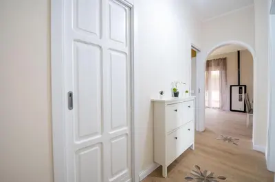 a white room with a door and a hallway at Villa Alma in Campofelice di Roccella