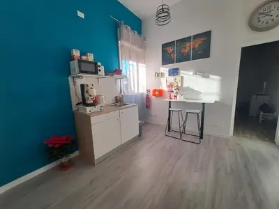 a small kitchen with a counter and a table at Bedroom la stazione in Palermo