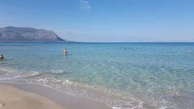 a group of people in the water at the beach at Arricàmpati Villa & Bringo Car Rental in Carini