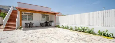 a patio of a house with a table and chairs at Arricàmpati Airport Rooms in Villa & RENT CAR in Carini