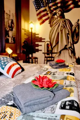 a bed with towels and a statue of the virgin mary at Guastella House in Palermo