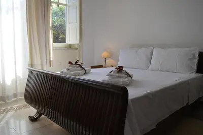 a bedroom with a bed with towels on it at mondello beach luxury apartments in Palermo