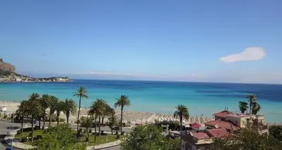 a view of the beach and the ocean at mondello beach luxury apartments in Palermo