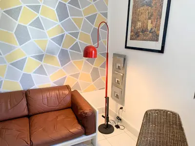 a living room with a couch and a red floor lamp at home.70 Carini in Palermo