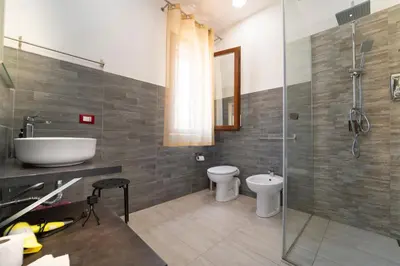 a bathroom with a sink and a toilet and a shower at B&B Kòre in Castellammare del Golfo