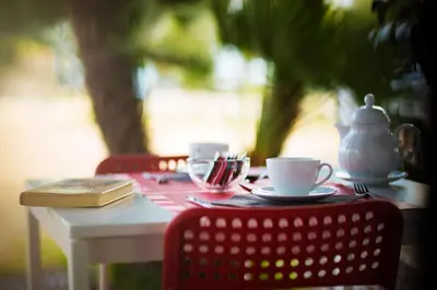 a table with two cups and a tea pot on it at B&B Kòre in Castellammare del Golfo