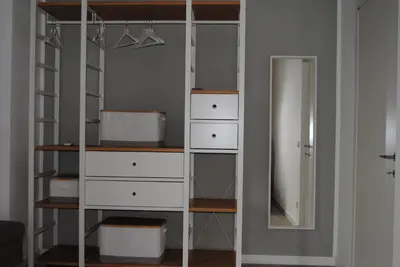 a closet with white drawers and a mirror at Villa Smeralda in San Vito lo Capo