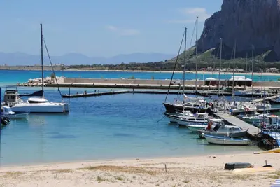 a group of boats docked at a dock in the water at Villa Smeralda in San Vito lo Capo