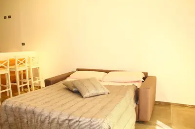 a bed with two pillows on it in a room at Sicilia d'Amare in Capaci
