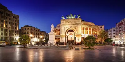 a building with a statue in front of it at night at Sicilia d'Amare in Capaci