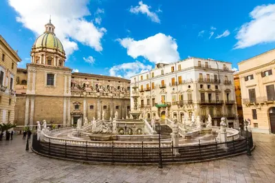 a city square with a fountain in front of a building at Sicilia d'Amare in Capaci