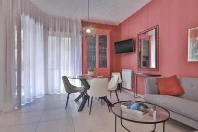 a living room with a table and a couch at Libertà Central Suites in Palermo