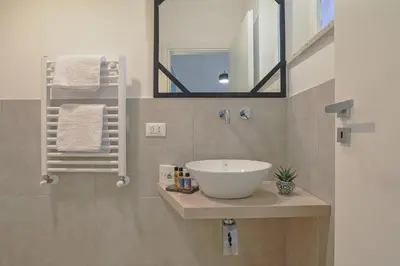 a bathroom with a sink and a mirror at Libertà Central Suites in Palermo