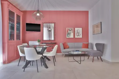 a living room with a couch and a table and chairs at Libertà Central Suites in Palermo