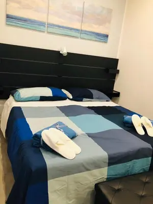 a bed with two pairs of towels on it at Dal Barce Rooms in Palermo