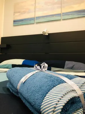 a bed with a blue blanket on top of it at Dal Barce Rooms in Palermo