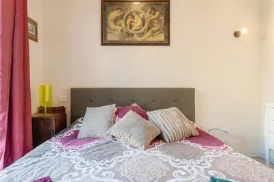 a bedroom with a bed with pillows on it at Arimatea Casa Vacanza in Palermo