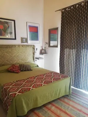 a bedroom with a bed and a window with curtains at Arimatea Casa Vacanza in Palermo