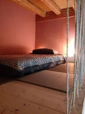 a bedroom with a hanging bed in a room at Arimatea Casa Vacanza in Palermo