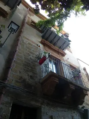a building with a balcony with plants on it at Arimatea Casa Vacanza in Palermo