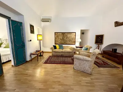 a living room with a couch and two chairs in it at Case Natoli - Residenze d'Epoca in Palermo