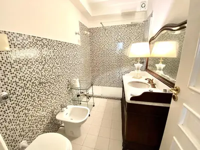 a bathroom with a sink and a toilet and a mirror at Case Natoli - Residenze d'Epoca in Palermo