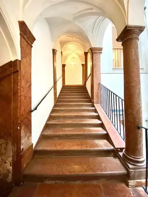 a stairway in an old building with stone walls and ceilings at Case Natoli - Residenze d'Epoca in Palermo