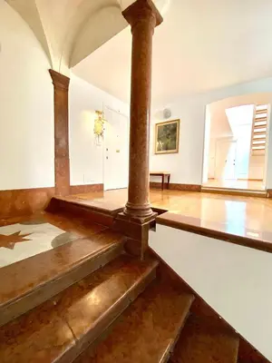 a room with a column and stairs in a building at Case Natoli - Residenze d'Epoca in Palermo