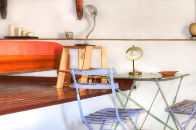 a desk with two chairs and a table with a lamp at Historical Penthause Ballarò with view in Palermo