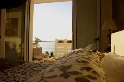a bedroom with a bed with a view of the ocean at Sea view life in Carini