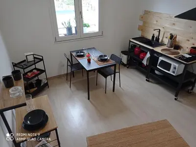 a living room with a table and a microwave at Sea view life in Carini