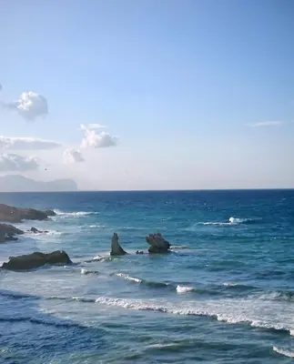 a view of the ocean with rocks in the water at Inkantu B&B in Terrasini