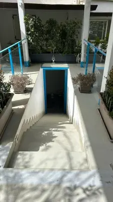 a tunnel in a building with a blue door at Villa DANAE in Mondello