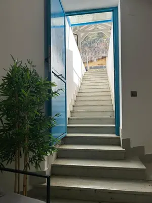 a staircase leading up to a building with a blue door at Villa DANAE in Mondello