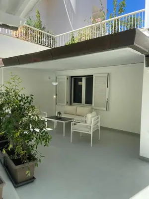 a patio with a couch and a table at Villa DANAE in Mondello