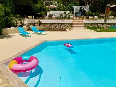 a swimming pool with a raft and a toy in it at Villa Flore - Penthouse - apartment in villa in Casteldaccia