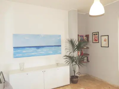 a white living room with a painting on the wall at Villa Flore - Penthouse - apartment in villa in Casteldaccia