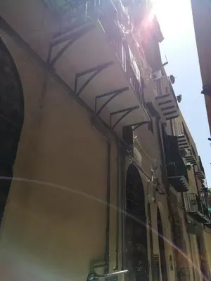 a building with the sun shining on the side of it at Il mio posto ai Quattro Canti - Centro storico Palermo in Palermo