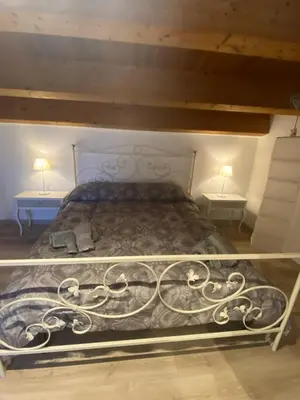 a bed in a room with two tables and two lamps at Il mio posto ai Quattro Canti - Centro storico Palermo in Palermo