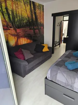 a living room with a couch and a painting on the wall at Virginia House 2 in Palermo