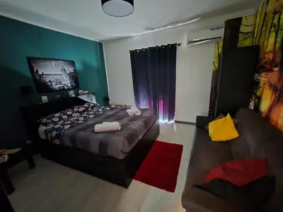 a bedroom with a bed and a couch at Virginia House 2 in Palermo