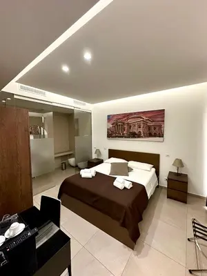 a bedroom with a large bed in a room at Suites Central Station in Palermo