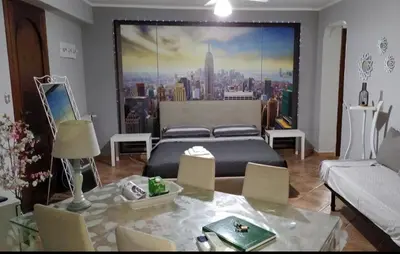 a bedroom with a bed and a large painting on the wall at New Island in Isola delle Femmine
