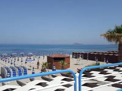 a view of the beach from a balcony at New Island in Isola delle Femmine