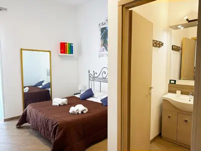 a room with a desk and a room with a table at Lucky Inn, La Locanda della Fortuna in Palermo