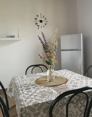 a dining room table with a vase of flowers on it at Villa Calcerame in Montelepre