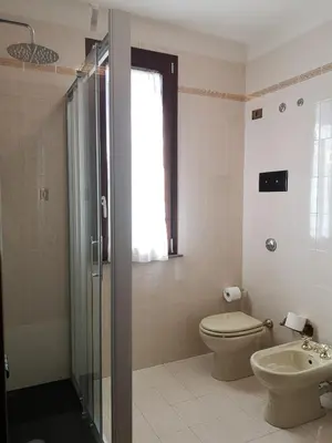 a bathroom with a shower and a toilet and a sink at Villa Calcerame in Montelepre