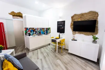 a group of pictures hanging on a wall at Agghiorna&skura house in Palermo